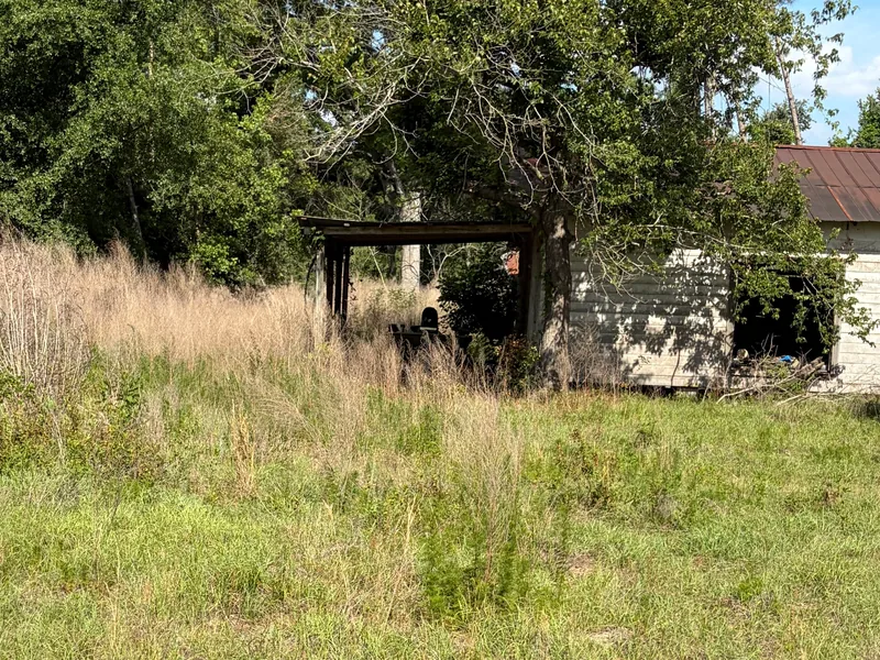Old shed in a partly cut field, demolition