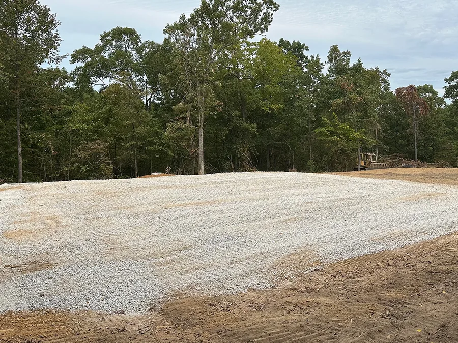 Built up pad capped with crushed stone on a cleared lot, mobile home pad