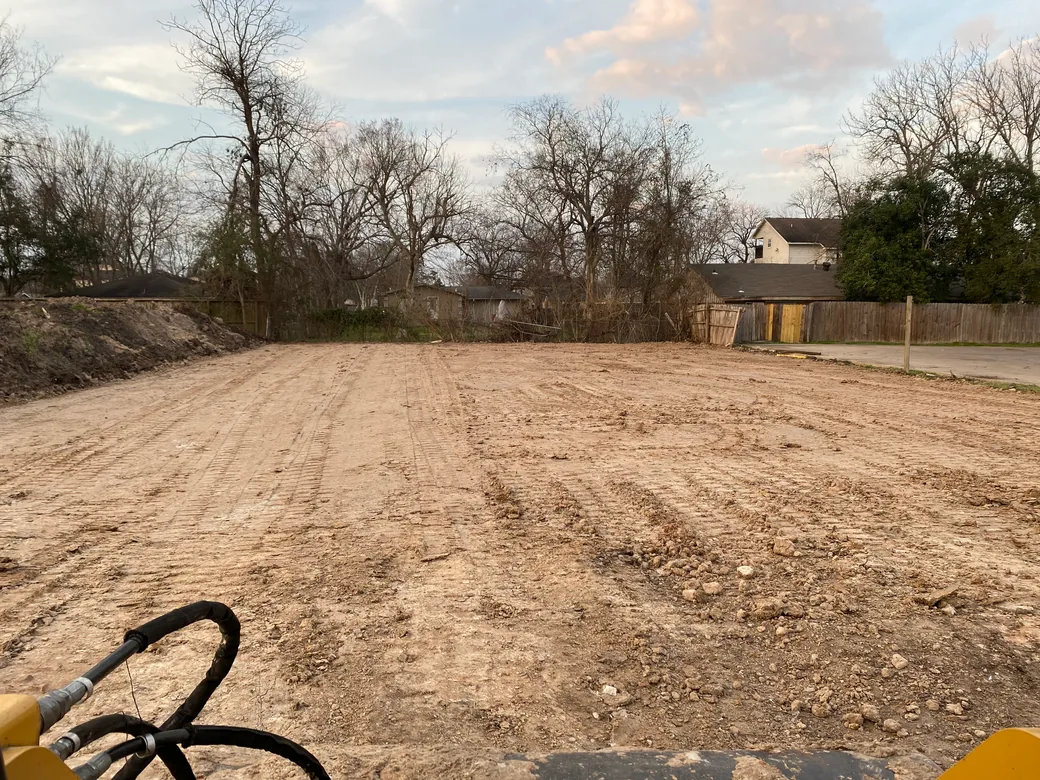 Cleared and rough graded house lot with fresh track marks, site preparation